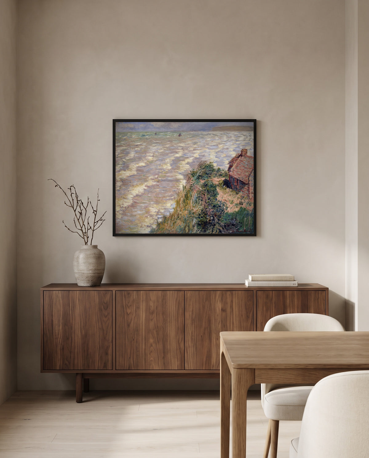 Rising Tide at Pourville by Claude Monet in a black frame above a walnut sideboard in a dining room