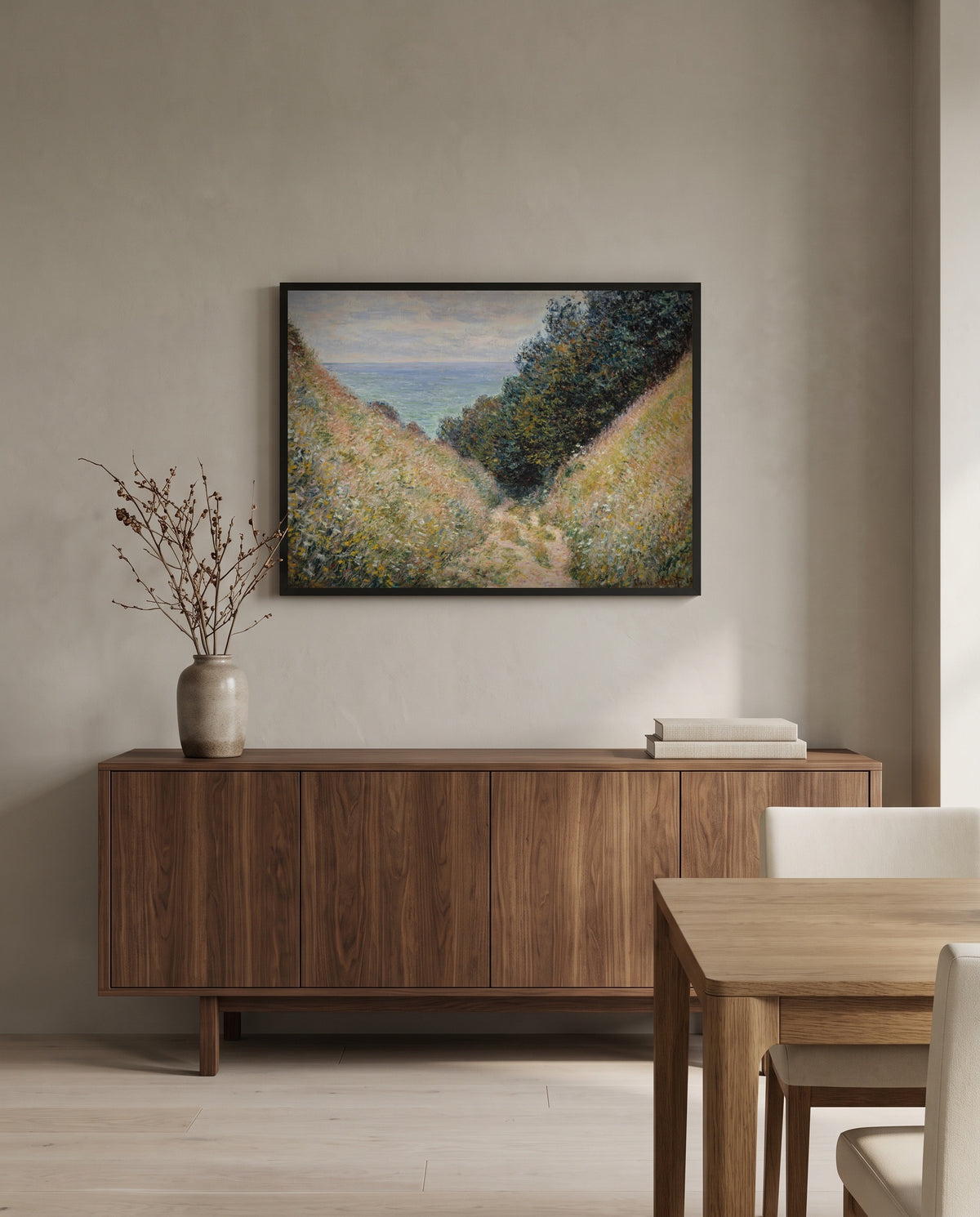 Road at La Cavée by Claude Monet in a black frame above a walnut sideboard in a dining room