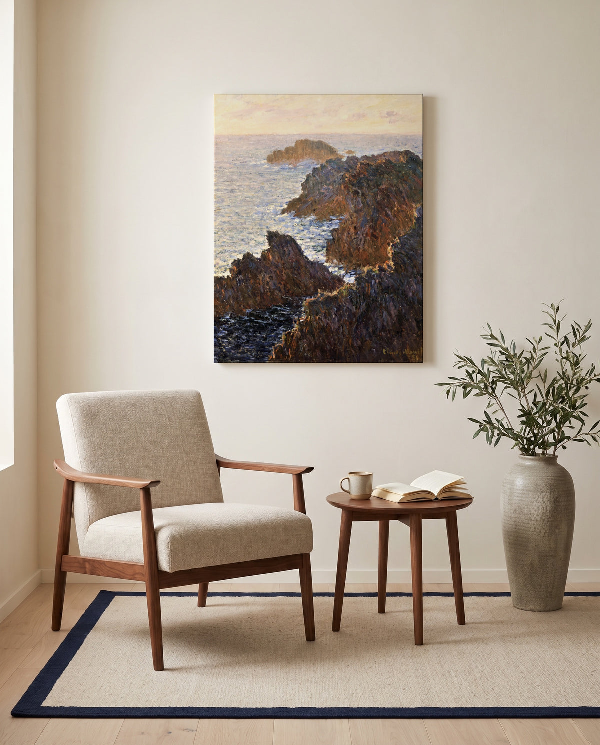 Rocks at Belle-Isle by Claude Monet as a stretched canvas above a linen lounge chair in a reading corner