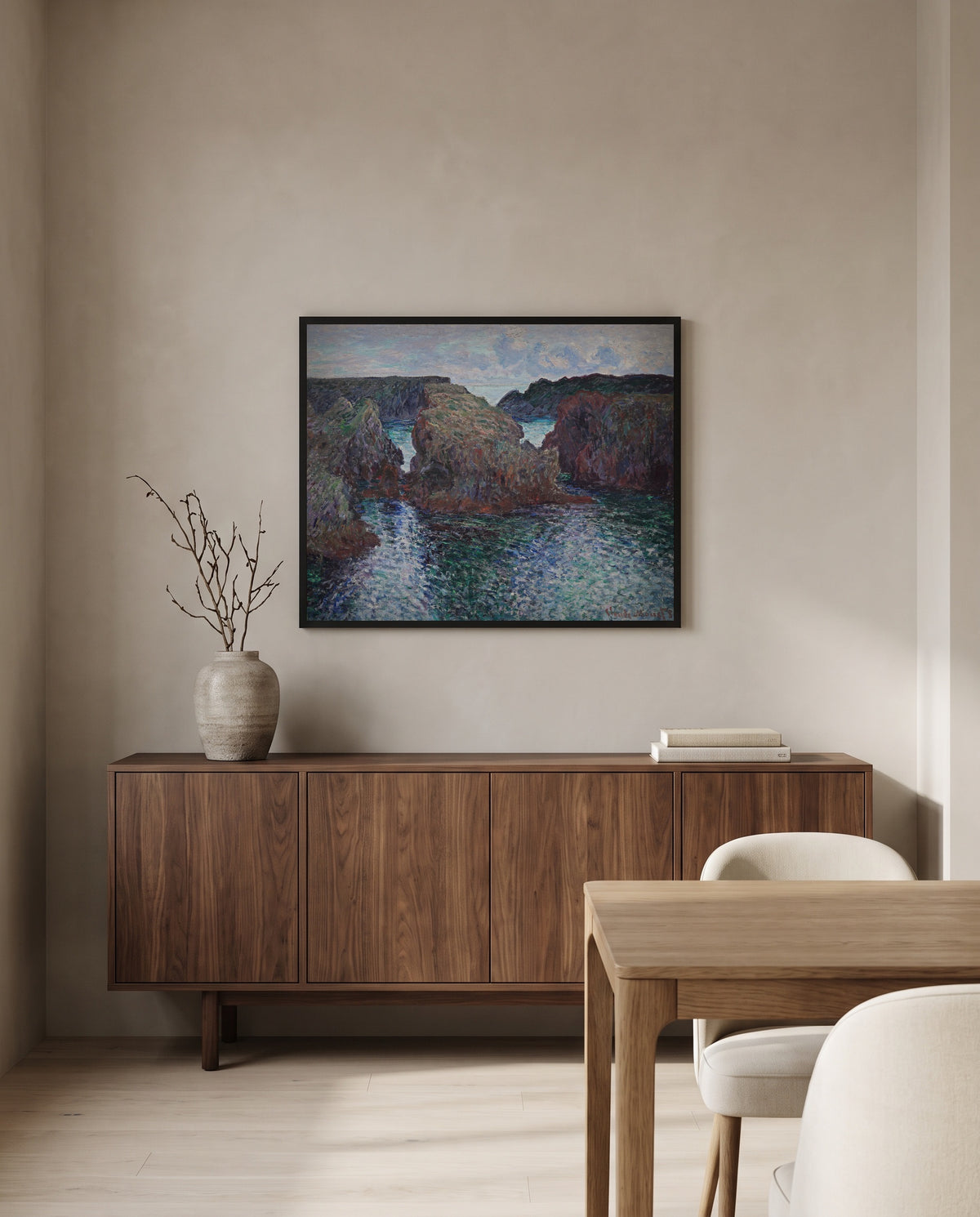 Rocks at Port-Goulphar, Belle-Île by Claude Monet in a black frame above a walnut sideboard in a dining room