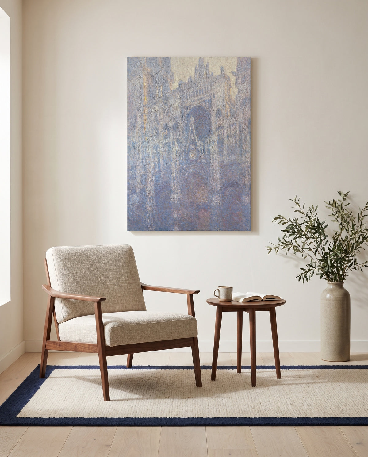 Rouen Cathedral, Morning by Claude Monet as a stretched canvas above a linen lounge chair in a reading corner