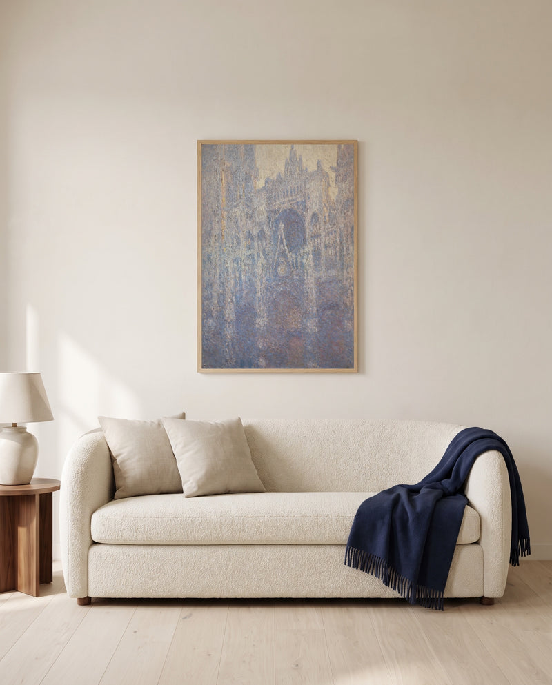 Rouen Cathedral, Morning by Claude Monet framed in natural oak above a cream sofa in a warm living room