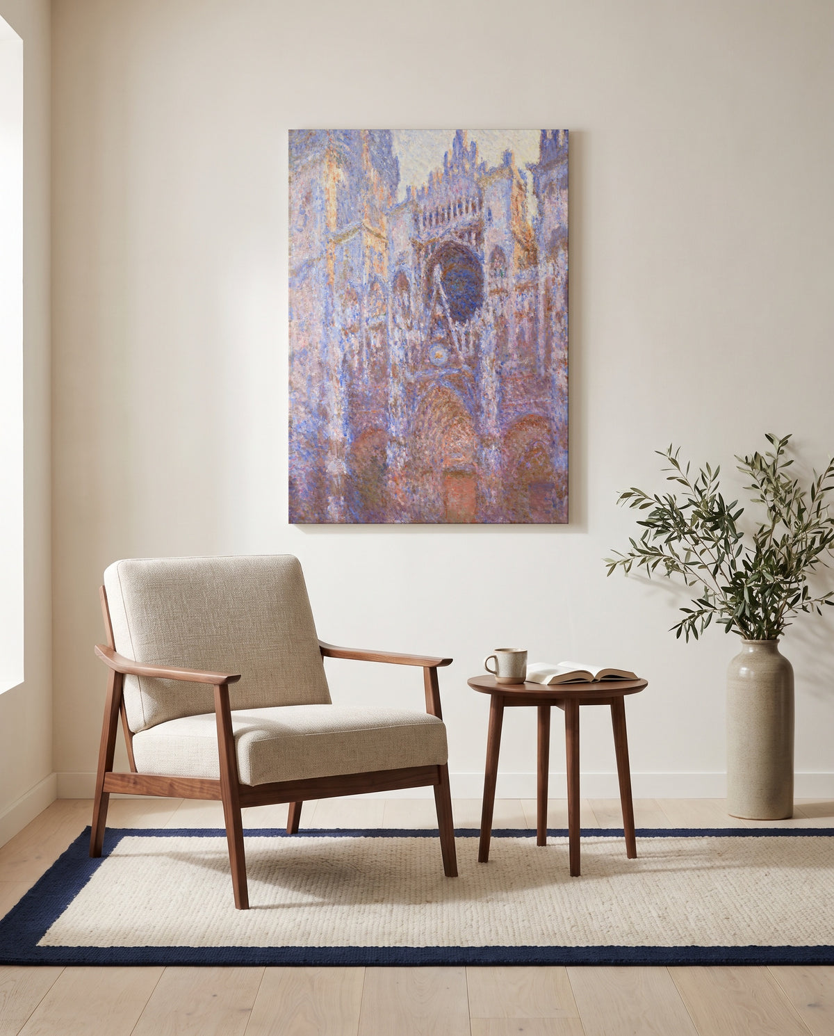 Rouen Cathedral, Façade by Claude Monet as a stretched canvas above a linen lounge chair in a reading corner