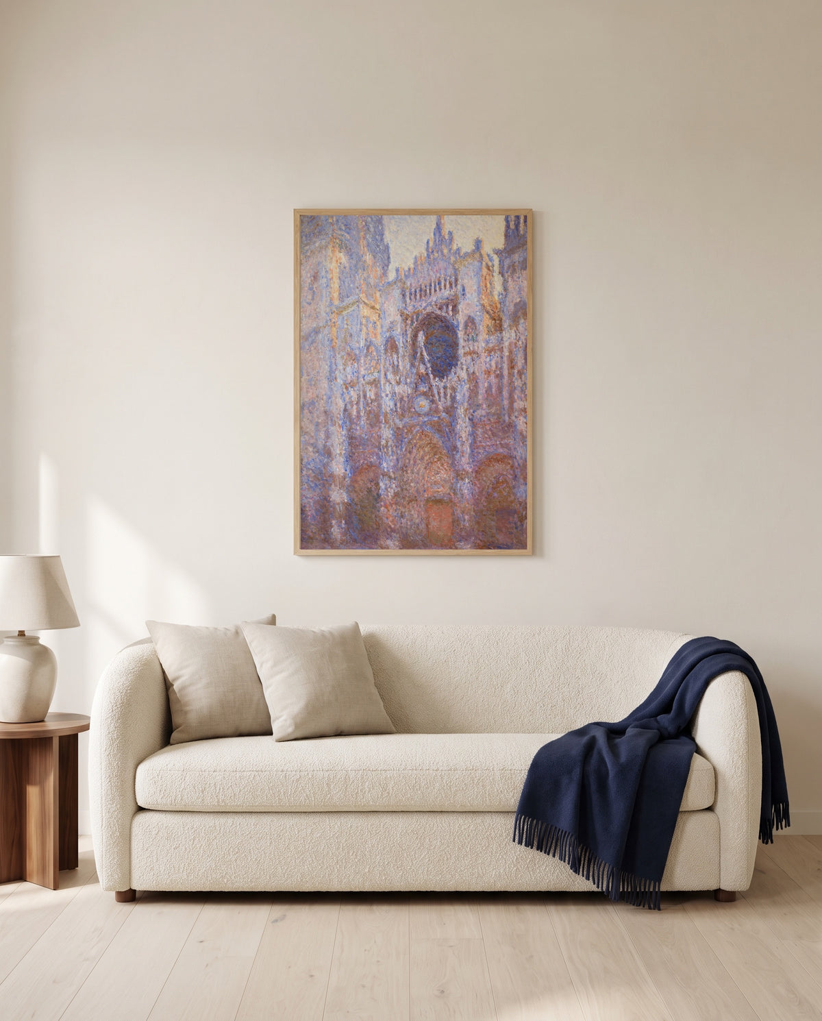 Rouen Cathedral, Façade by Claude Monet framed in natural oak above a cream sofa in a warm living room