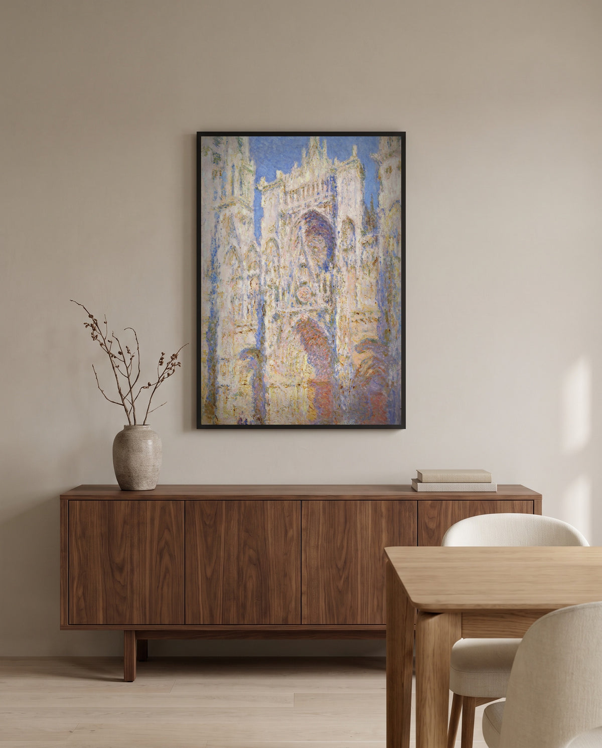 Rouen Cathedral, Sunlight by Claude Monet in a black frame above a walnut sideboard in a dining room