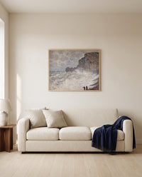 Rough Weather at Étretat by Claude Monet framed in natural oak above a cream sofa in a warm living room