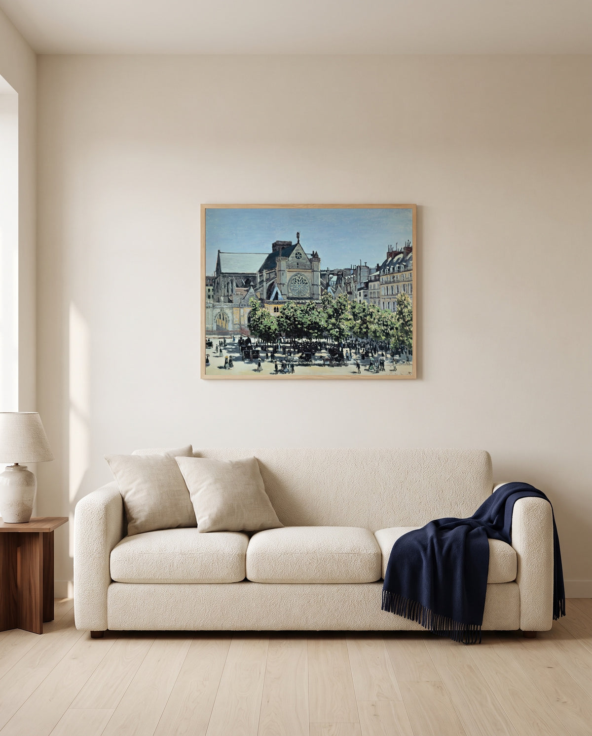 Saint-Germain-l’Auxerrois by Claude Monet framed in natural oak above a cream sofa in a warm living room