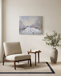 Snow at Argenteuil by Claude Monet as a stretched canvas above a linen lounge chair in a reading corner