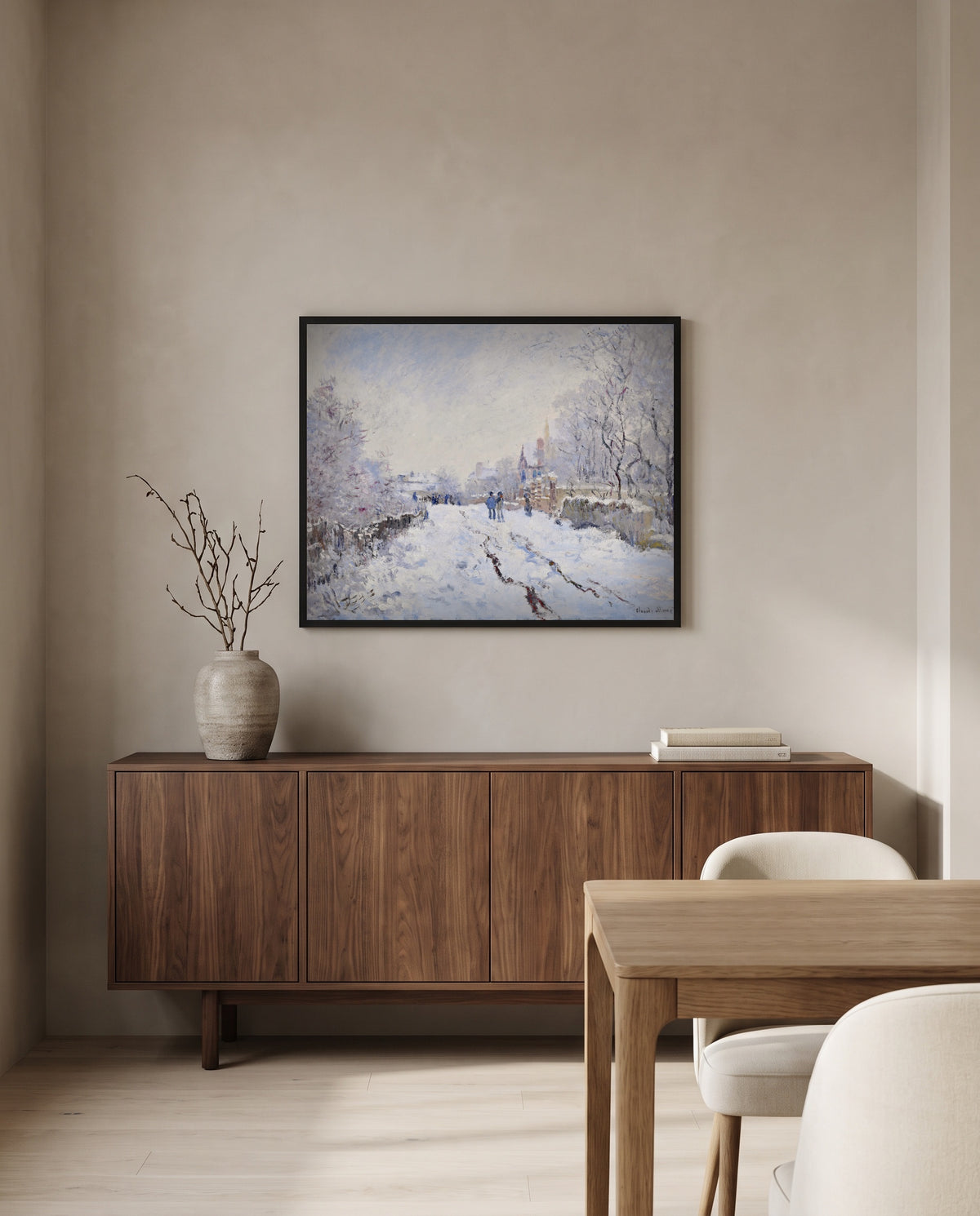 Snow at Argenteuil by Claude Monet in a black frame above a walnut sideboard in a dining room