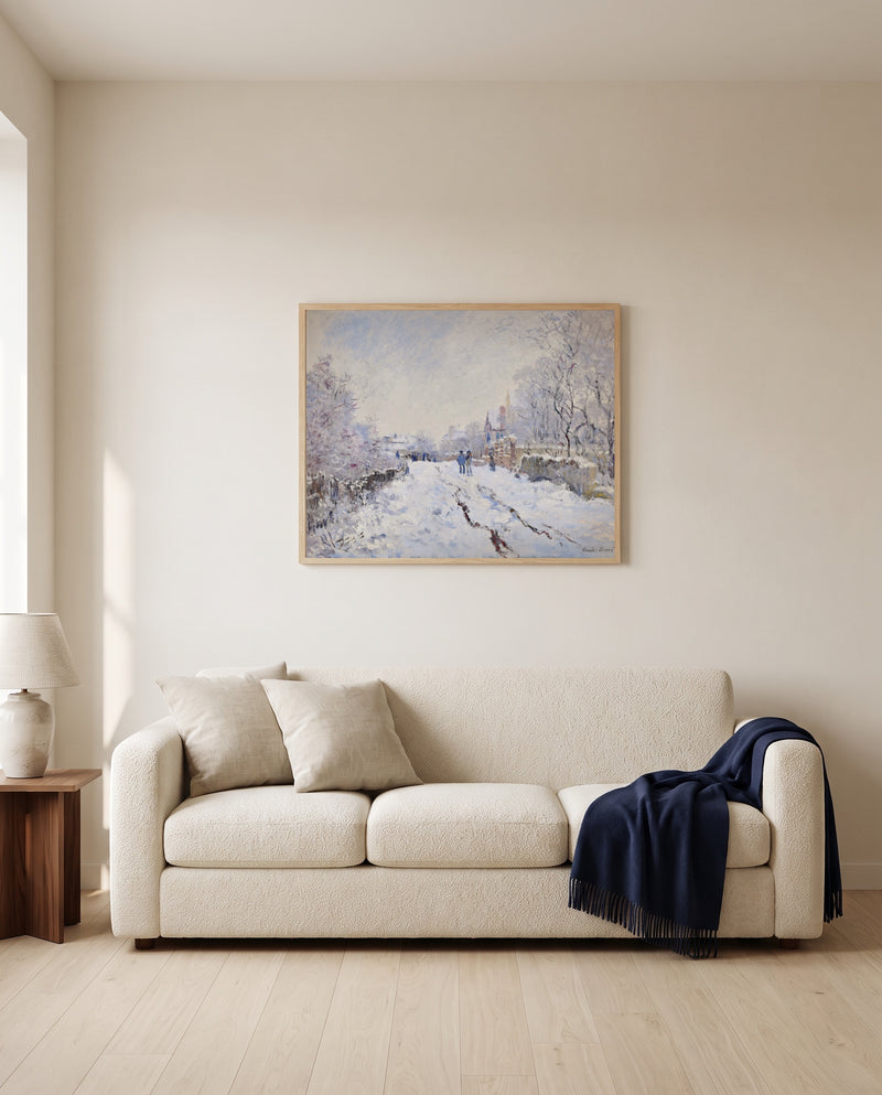 Snow at Argenteuil by Claude Monet framed in natural oak above a cream sofa in a warm living room