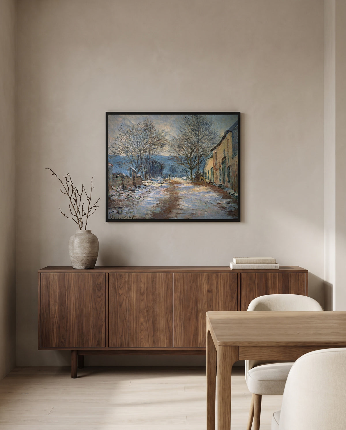 Snow Effect at Limetz by Claude Monet in a black frame above a walnut sideboard in a dining room