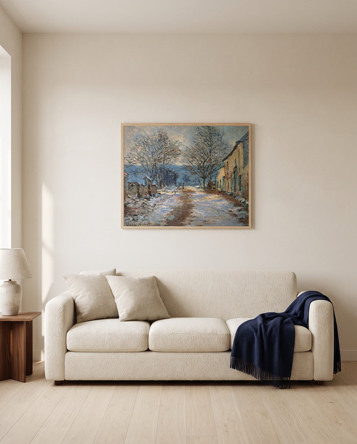 Snow Effect at Limetz by Claude Monet framed in natural oak above a cream sofa in a warm living room