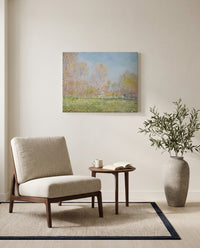 Spring in Giverny by Claude Monet as a stretched canvas above a linen lounge chair in a reading corner