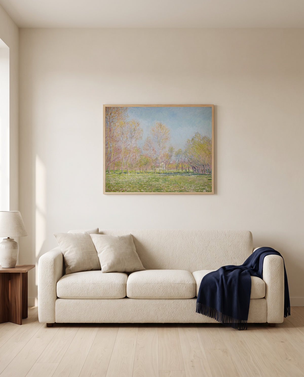 Spring in Giverny by Claude Monet framed in natural oak above a cream sofa in a warm living room