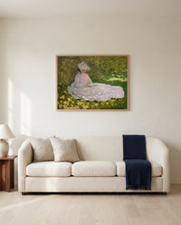 Springtime by Claude Monet framed in natural oak above a cream sofa in a warm living room