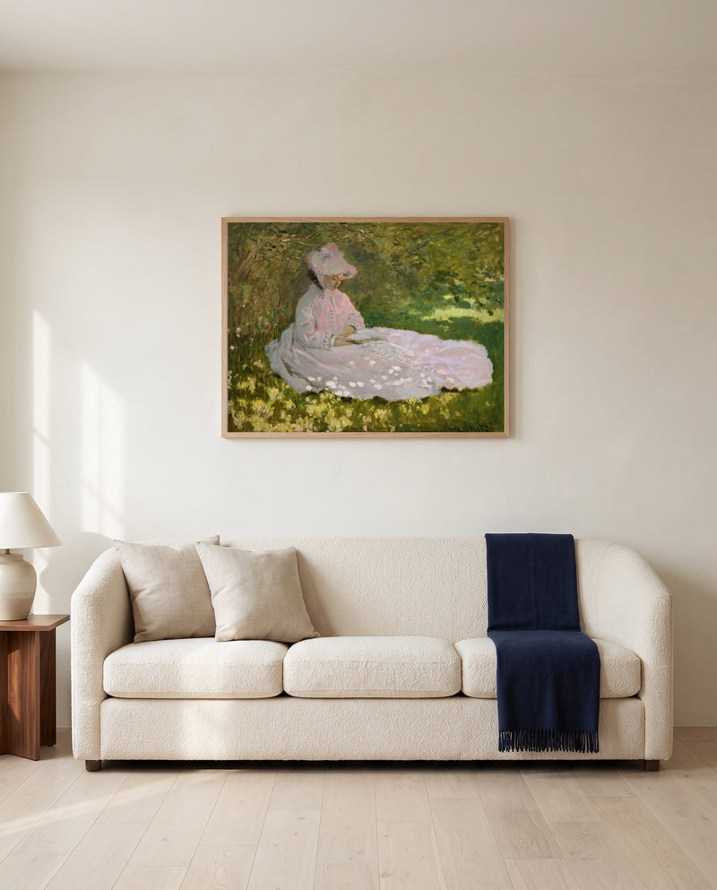 Springtime by Claude Monet framed in natural oak above a cream sofa in a warm living room
