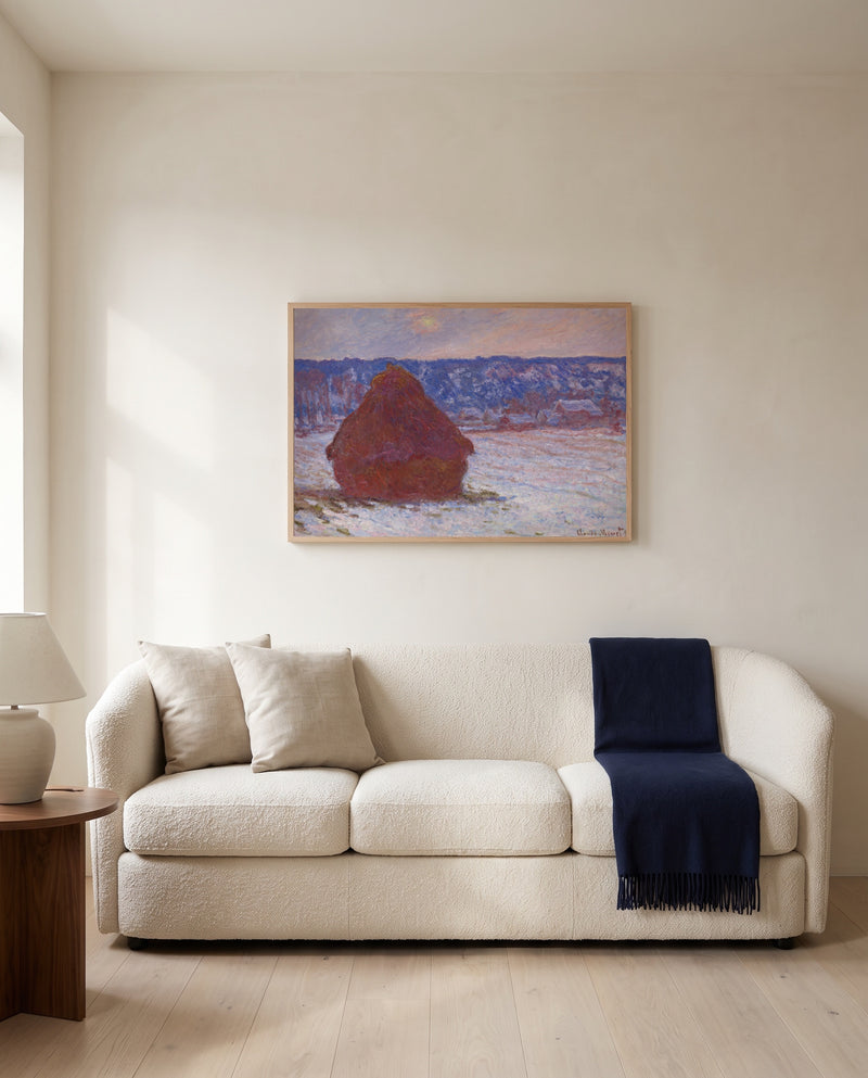 Stack of Wheat, Overcast by Claude Monet framed in natural oak above a cream sofa in a warm living room