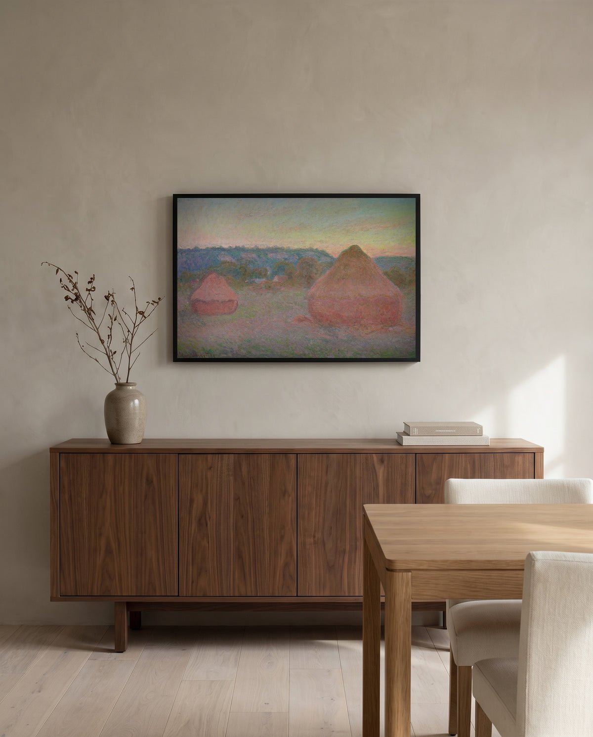 Stacks of Wheat, End of Day by Claude Monet in a black frame above a walnut sideboard in a dining room