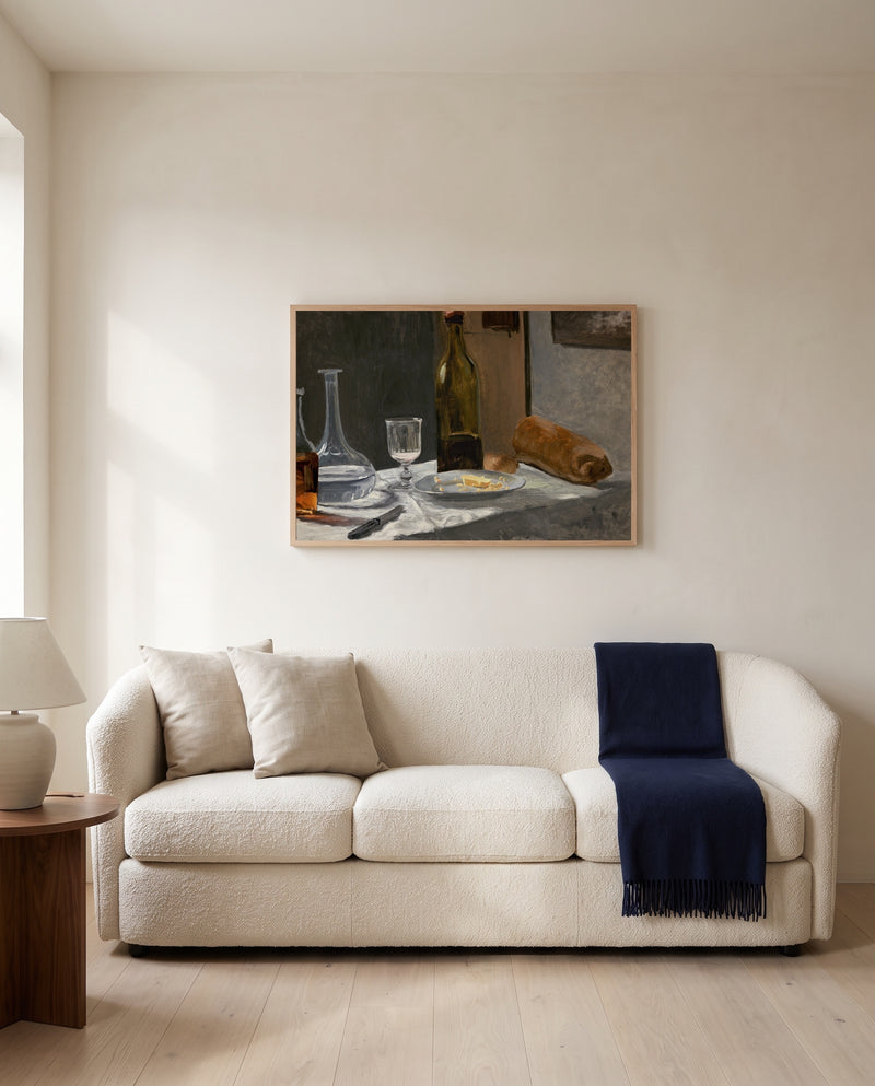 Bread and Wine by Claude Monet framed in natural oak above a cream sofa in a warm living room