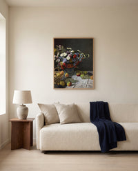 Flowers and Fruit by Claude Monet framed in natural oak above a cream sofa in a warm living room