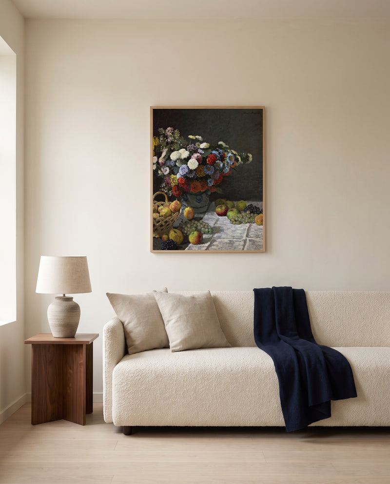 Flowers and Fruit by Claude Monet framed in natural oak above a cream sofa in a warm living room