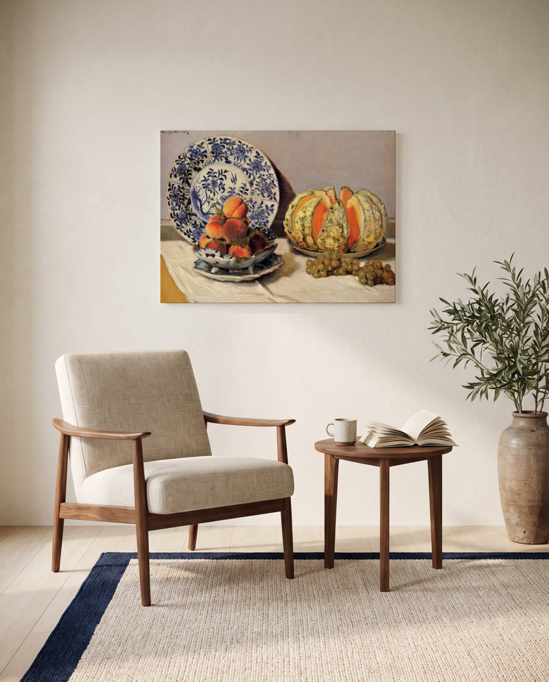 Still Life with Melon by Claude Monet as a stretched canvas above a linen lounge chair in a reading corner