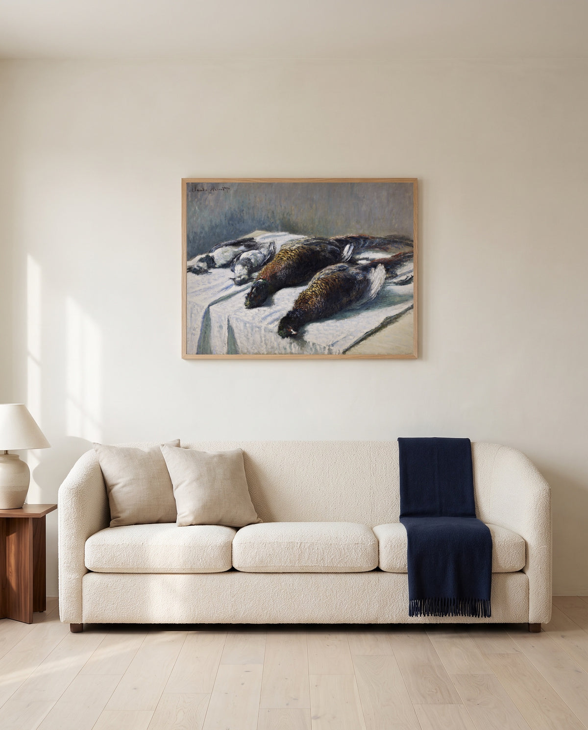 Pheasants and Plovers by Claude Monet framed in natural oak above a cream sofa in a warm living room
