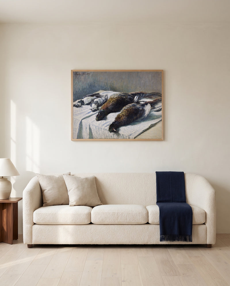 Pheasants and Plovers by Claude Monet framed in natural oak above a cream sofa in a warm living room