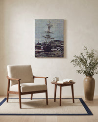Stranded Boat at Fécamp by Claude Monet as a stretched canvas above a linen lounge chair in a reading corner