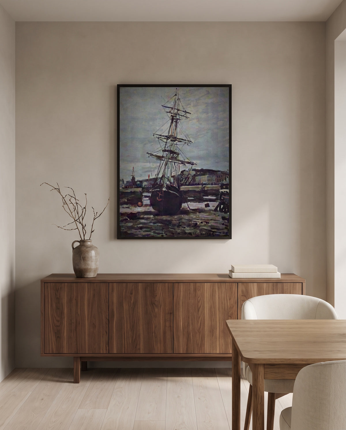 Stranded Boat at Fécamp by Claude Monet in a black frame above a walnut sideboard in a dining room