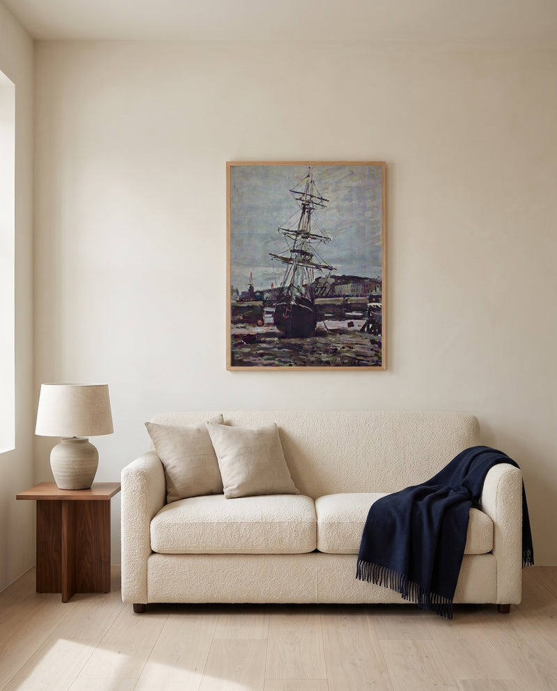 Stranded Boat at Fécamp by Claude Monet framed in natural oak above a cream sofa in a warm living room