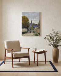 Street in Sainte-Adresse by Claude Monet as a stretched canvas above a linen lounge chair in a reading corner