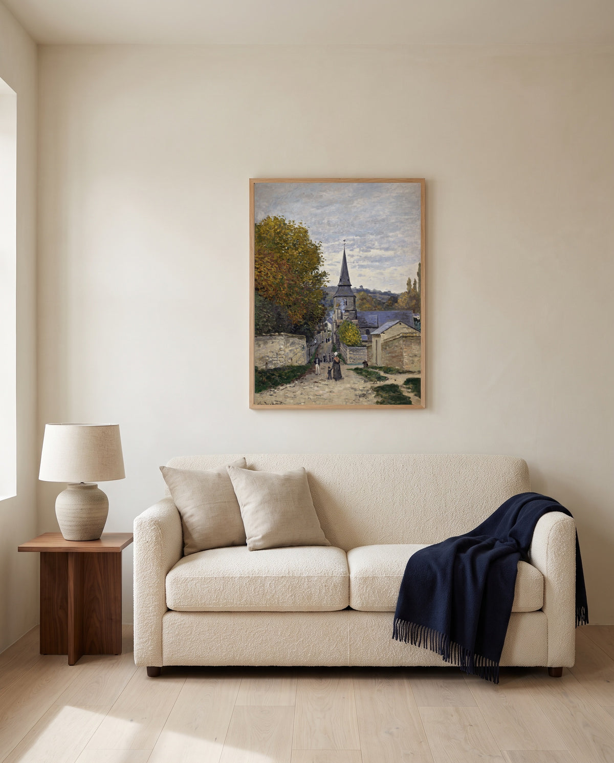 Street in Sainte-Adresse by Claude Monet framed in natural oak above a cream sofa in a warm living room