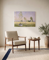 Summer, Meadow at Bezons by Claude Monet as a stretched canvas above a linen lounge chair in a reading corner