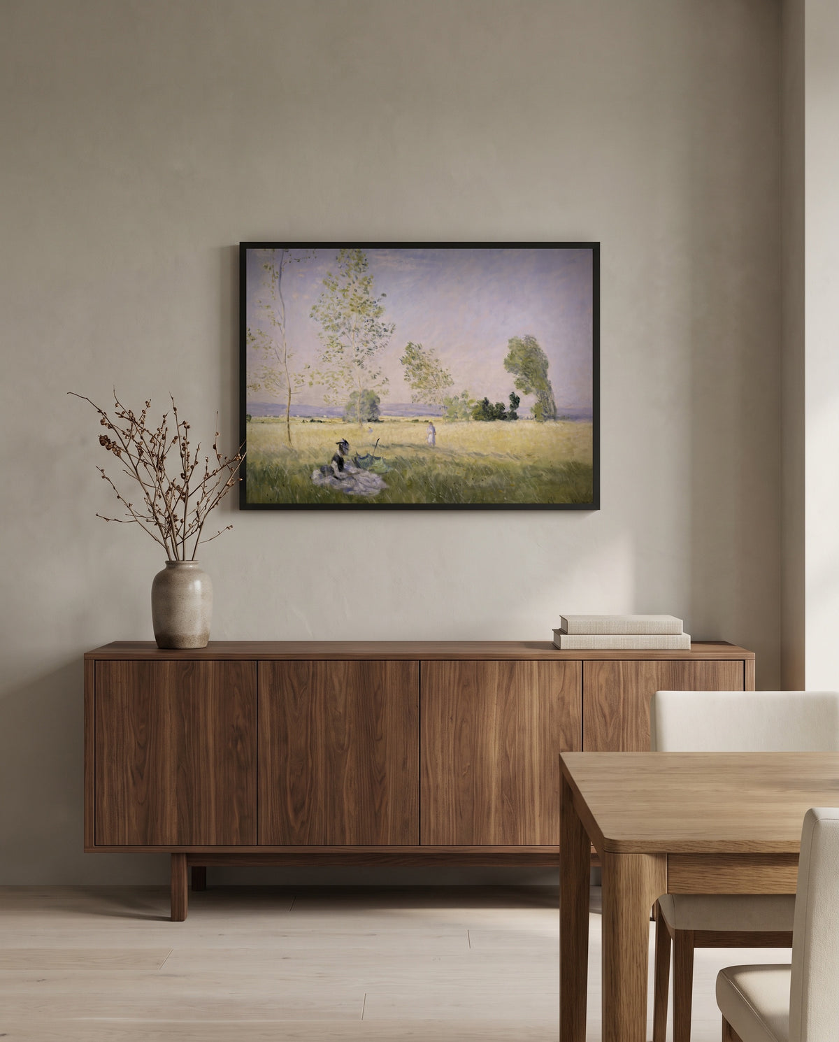 Summer, Meadow at Bezons by Claude Monet in a black frame above a walnut sideboard in a dining room