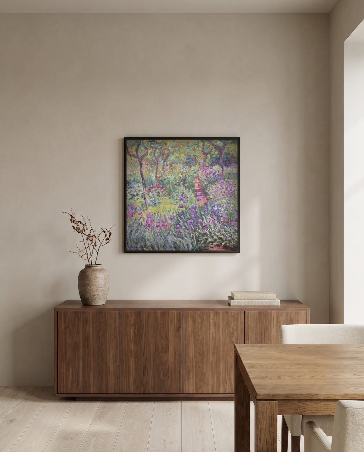 The Artist’s Garden, Giverny by Claude Monet in a black frame above a walnut sideboard in a dining room