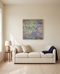 The Artist’s Garden, Giverny by Claude Monet framed in natural oak above a cream sofa in a warm living room