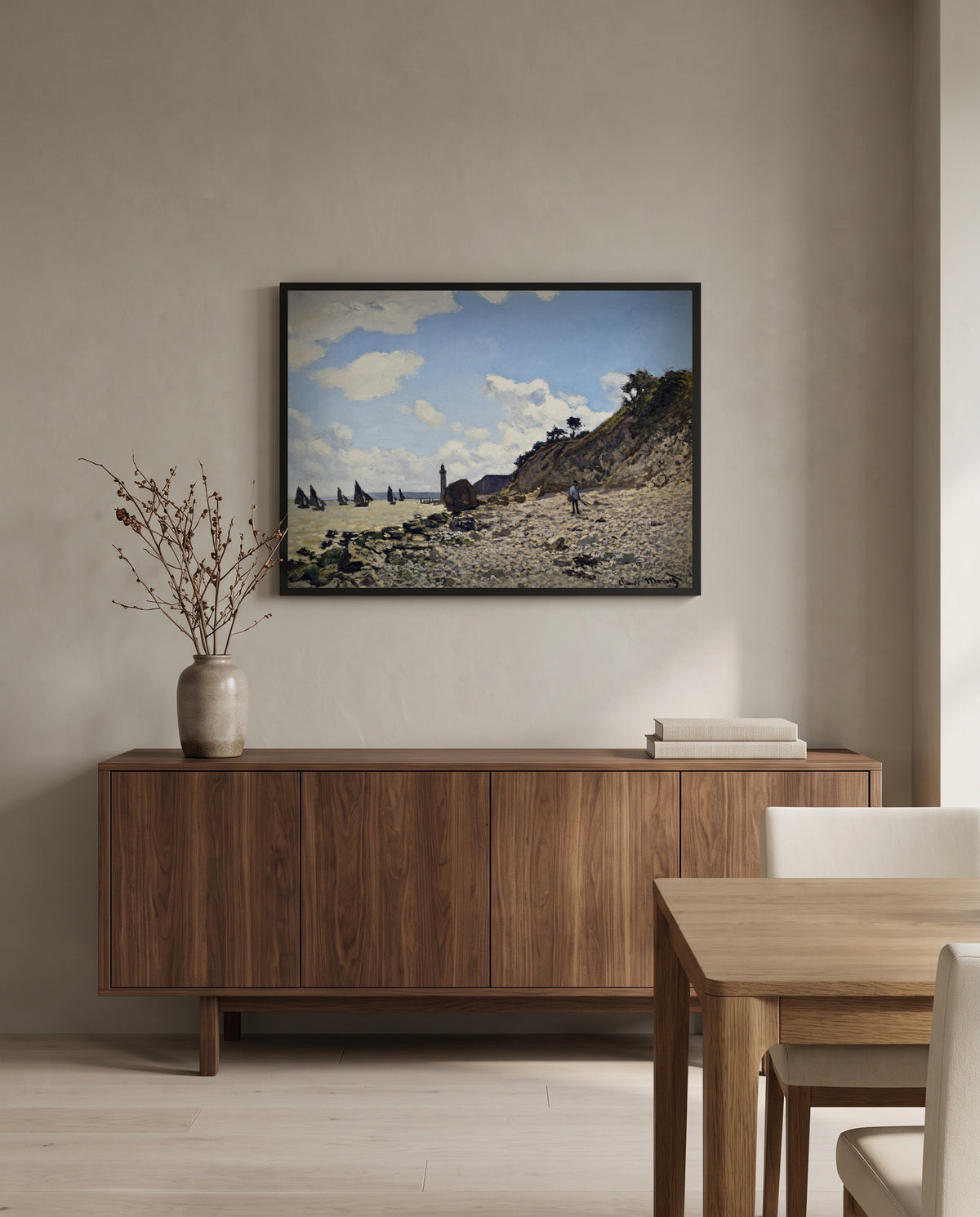 The Beach at Honfleur by Claude Monet in a black frame above a walnut sideboard in a dining room