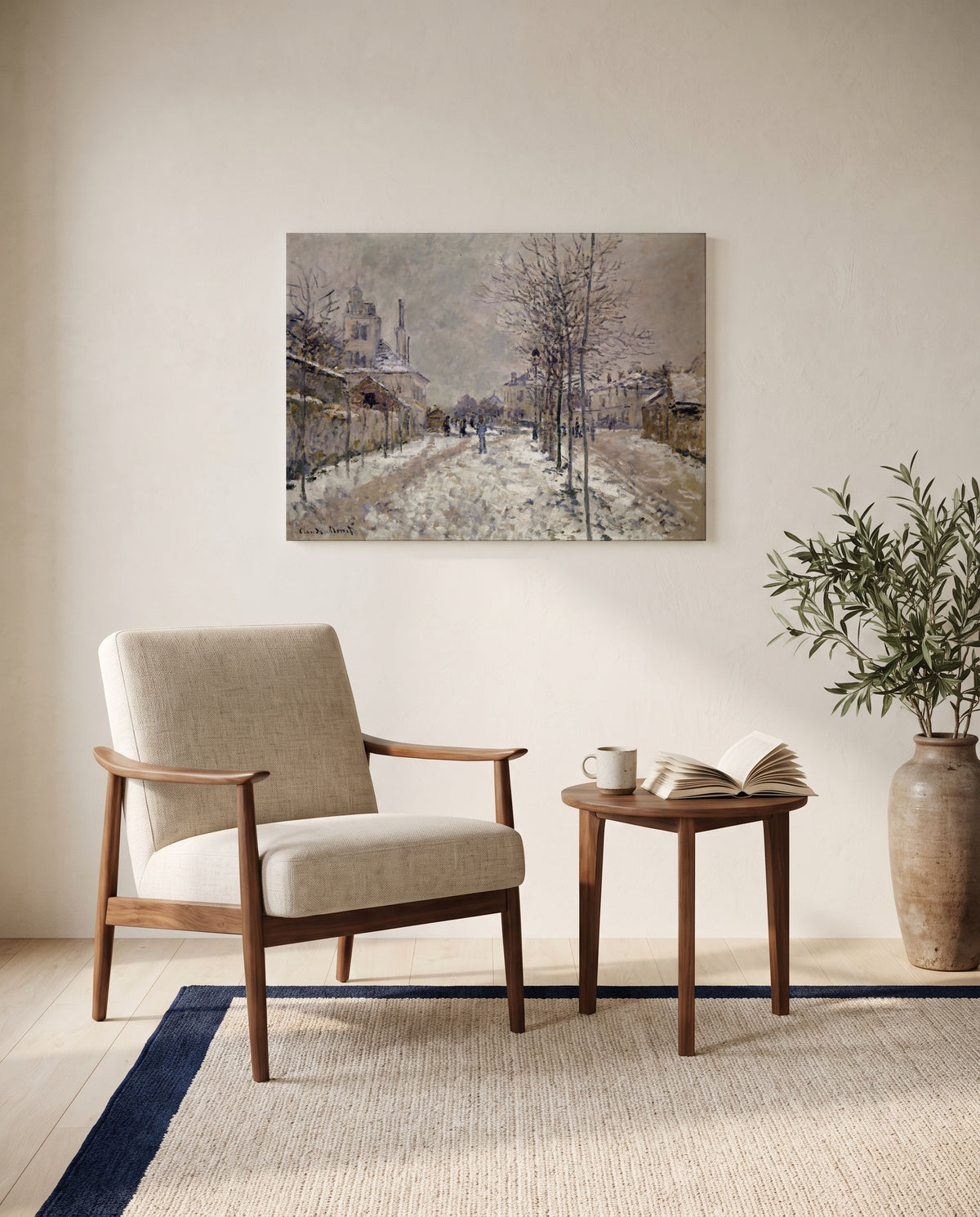 Boulevard de Pontoise, Snow by Claude Monet as a stretched canvas above a linen lounge chair in a reading corner