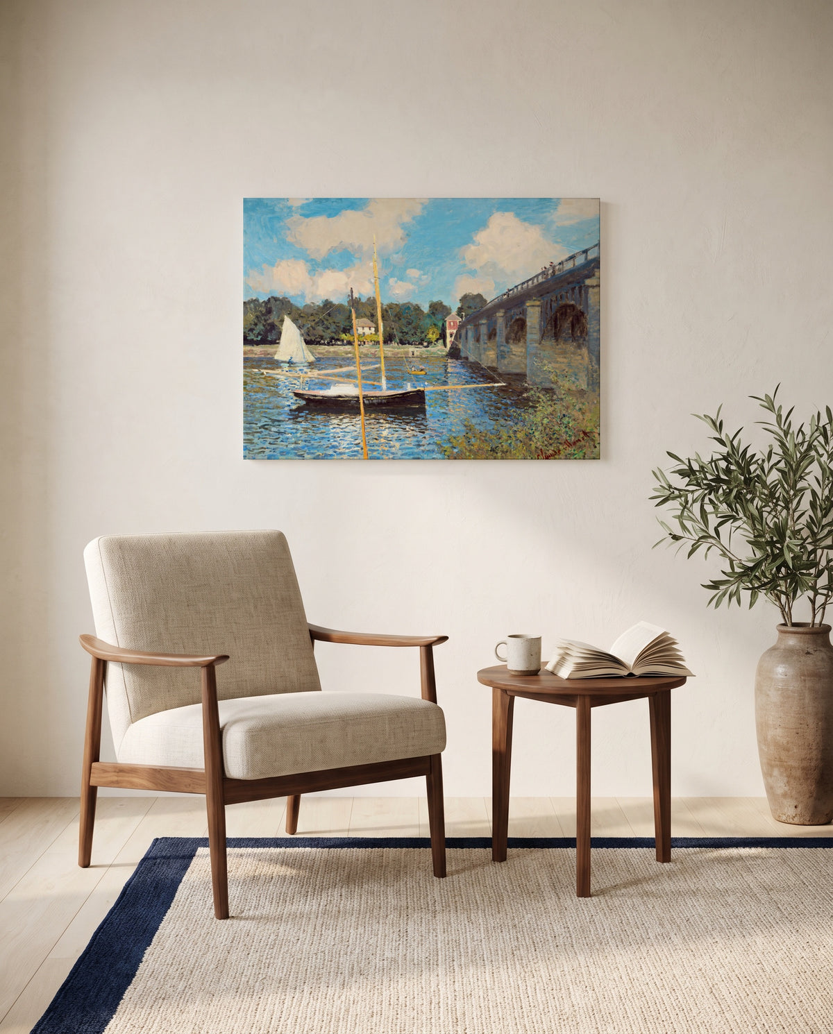 The Bridge at Argenteuil by Claude Monet as a stretched canvas above a linen lounge chair in a reading corner