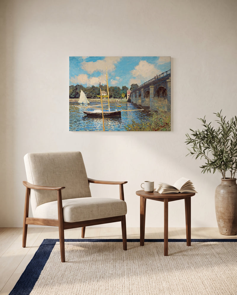 The Bridge at Argenteuil by Claude Monet as a stretched canvas above a linen lounge chair in a reading corner