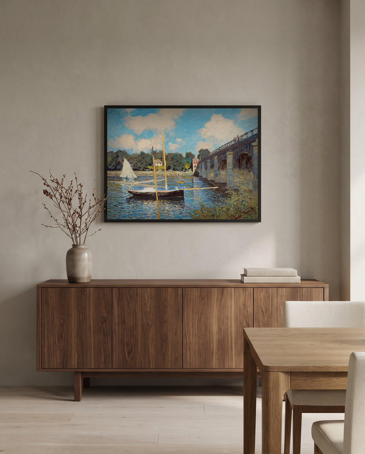 The Bridge at Argenteuil by Claude Monet in a black frame above a walnut sideboard in a dining room