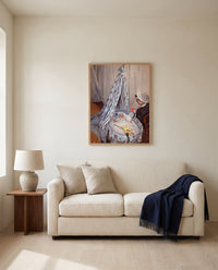 The Cradle by Claude Monet framed in natural oak above a cream sofa in a warm living room