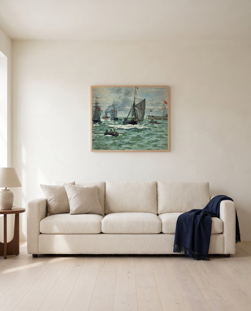 Port of Le Havre Entrance by Claude Monet framed in natural oak above a cream sofa in a warm living room