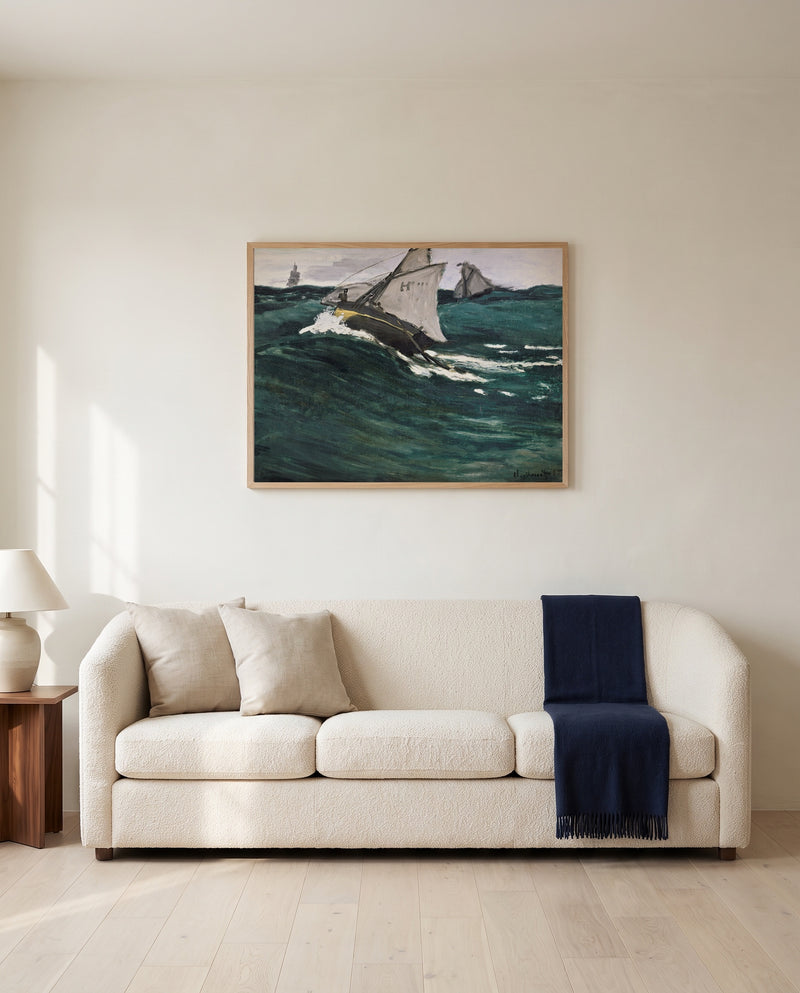 The Green Wave by Claude Monet framed in natural oak above a cream sofa in a warm living room