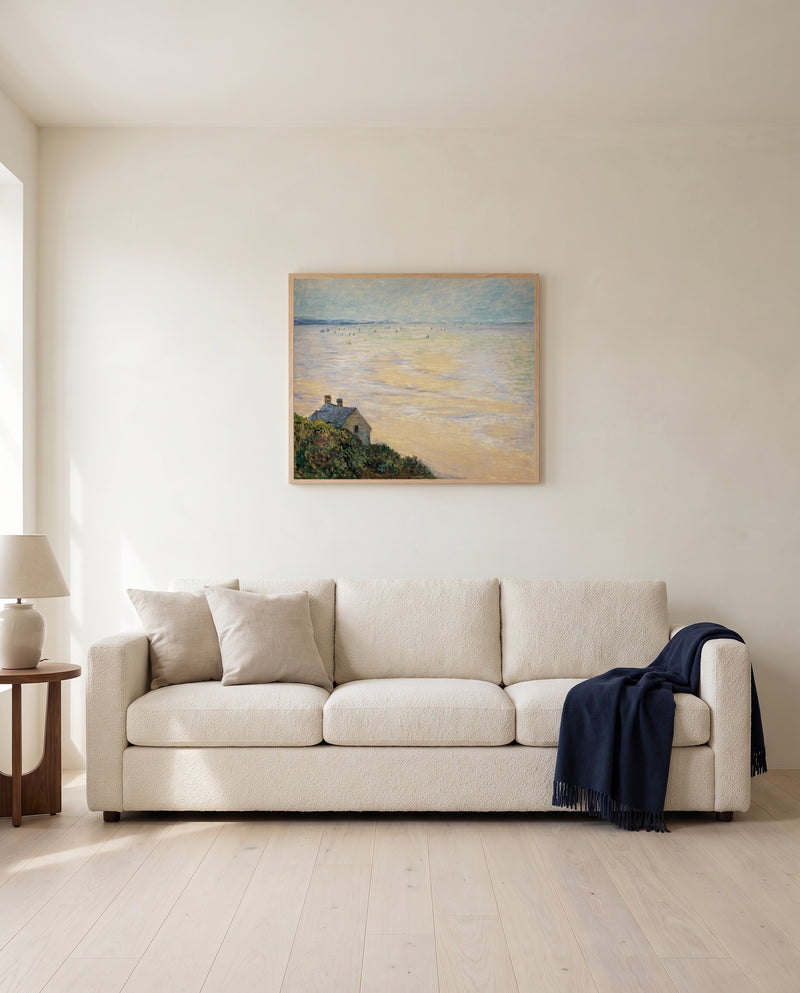 Hut at Trouville by Claude Monet framed in natural oak above a cream sofa in a warm living room