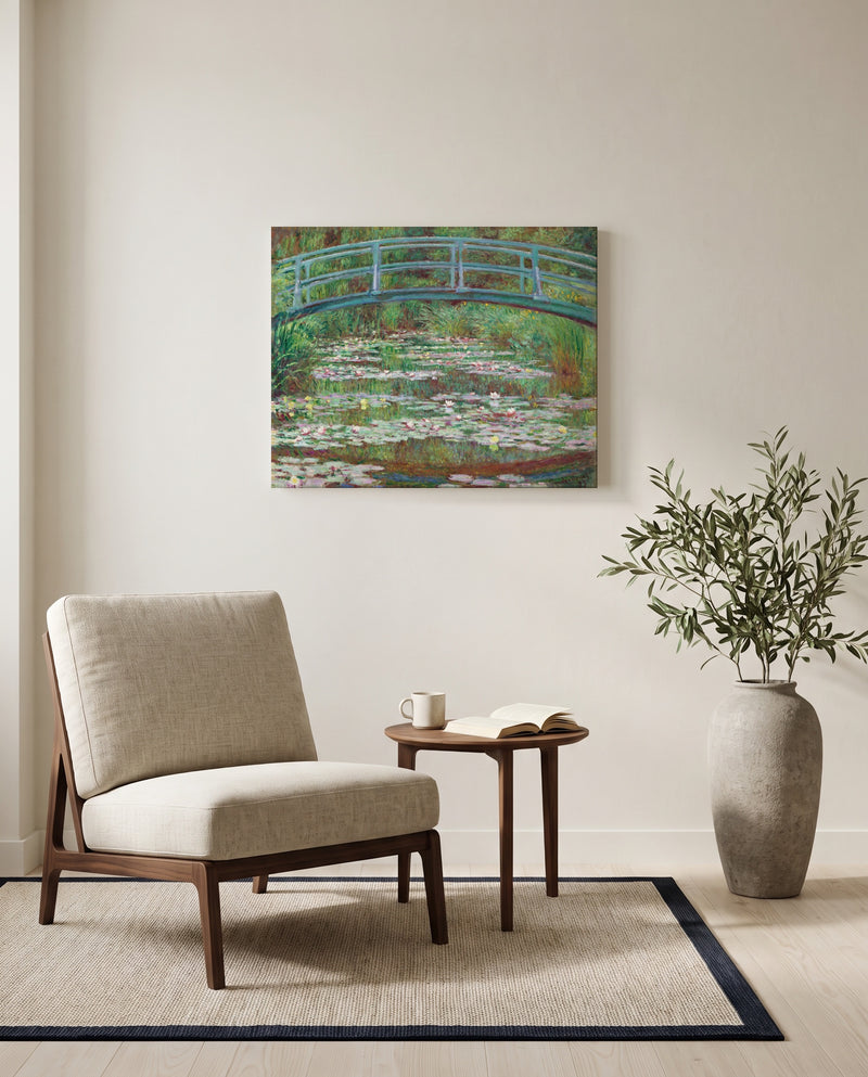 The Japanese Footbridge by Claude Monet as a stretched canvas above a linen lounge chair in a reading corner