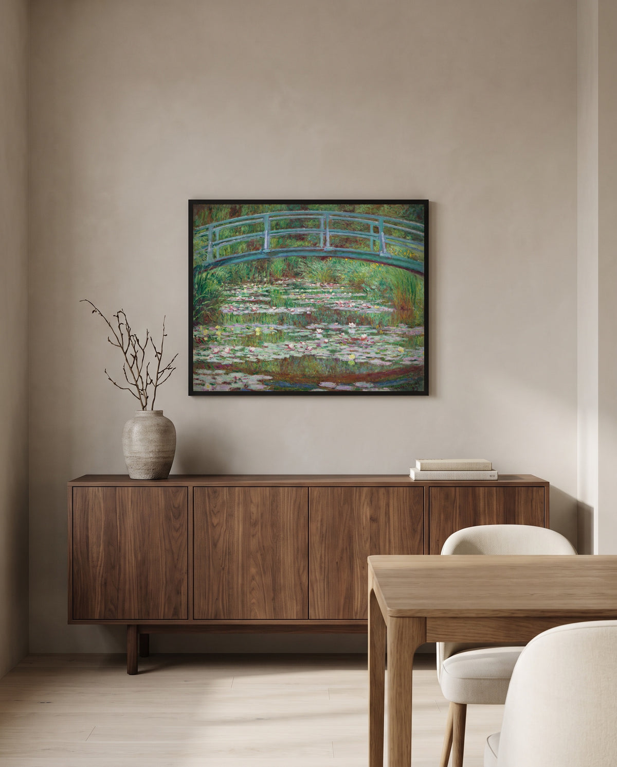 The Japanese Footbridge by Claude Monet in a black frame above a walnut sideboard in a dining room
