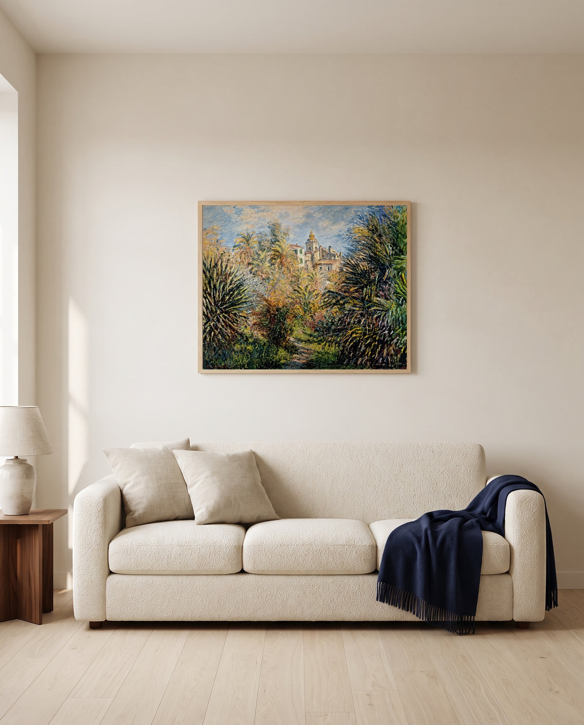The Moreno Garden by Claude Monet framed in natural oak above a cream sofa in a warm living room
