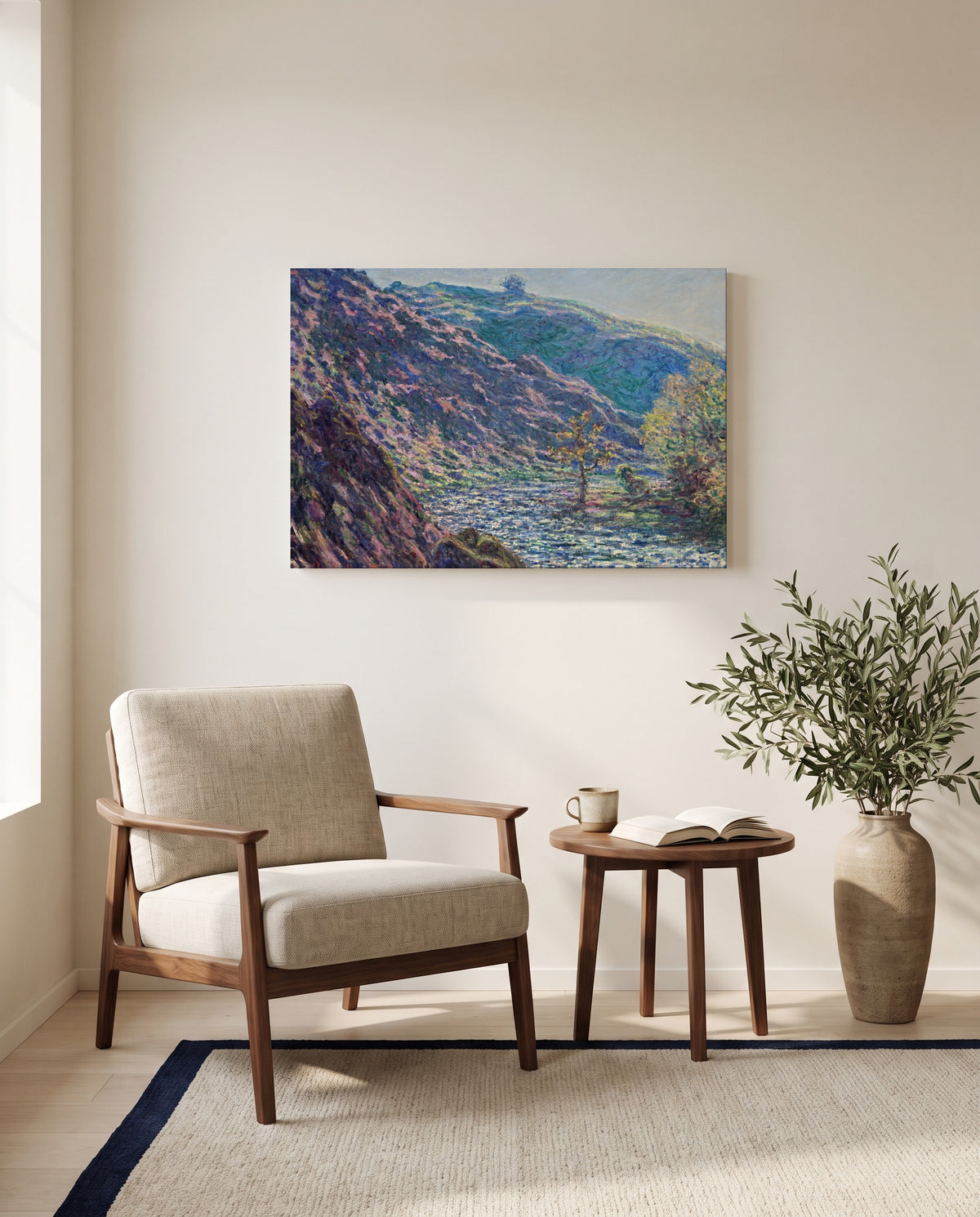 The Petite Creuse River by Claude Monet as a stretched canvas above a linen lounge chair in a reading corner